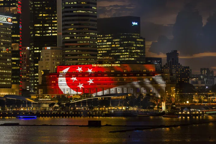 Singapore flag on facade of The Fullerton Hotel Singapore.