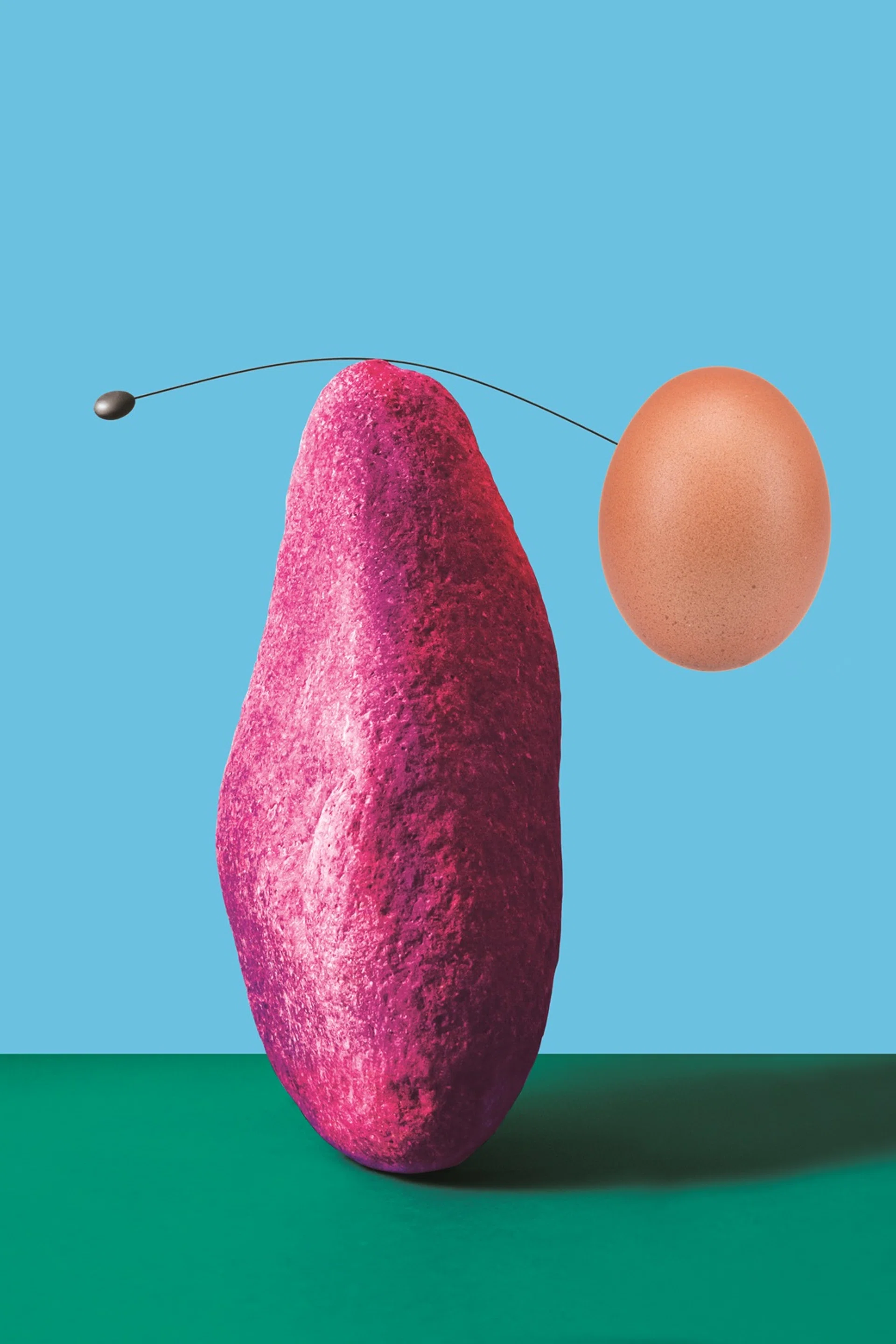 An abstract expression in which large and small balls connected to both ends of a piano wire are balanced on a stone with a narrow tip.