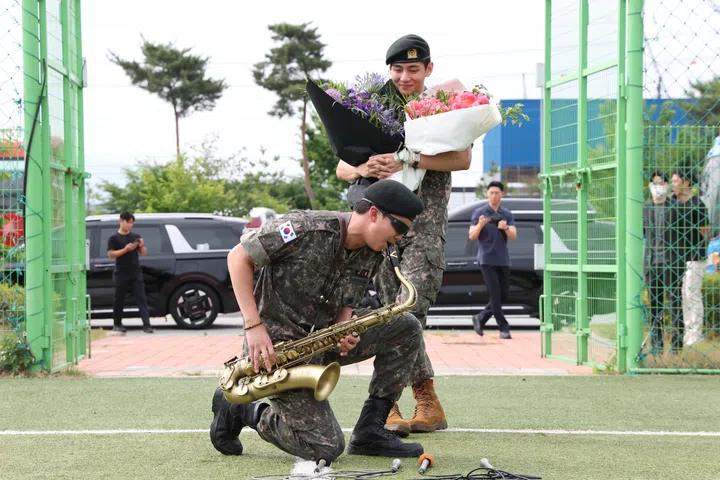 CHUNCHEON, SOUTH KOREA - JUNE 10: K-pop band BTS's members RM (L) and V (R) react after being discharged from a mandatory military service on June 10, 2025 in Chuncheon, South Korea. Four members of the K-pop group BTS's RM, V, Jimin and Jungkook will be discharged from their mandatory 18-month military service next week, the boy band's agency said. RM, the leader of the group, and V completed the 18-month mandatory military service, which is required for all able-bodied male citizens in South Korea before they turn 28, followed by Jimin and Jungkook the next day, according to BigHit Music. (Photo by Chung Sung-Jun/Getty Images)