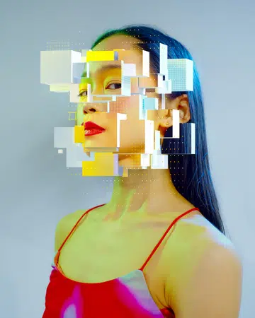 Digital generated image of young japanese woman scattering into cubes.  Metaverse and Web3.0 concept.