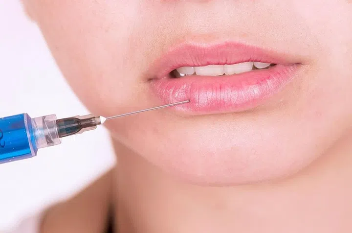 Close up shot of lips getting botox injection, concept of cosmetic treatment