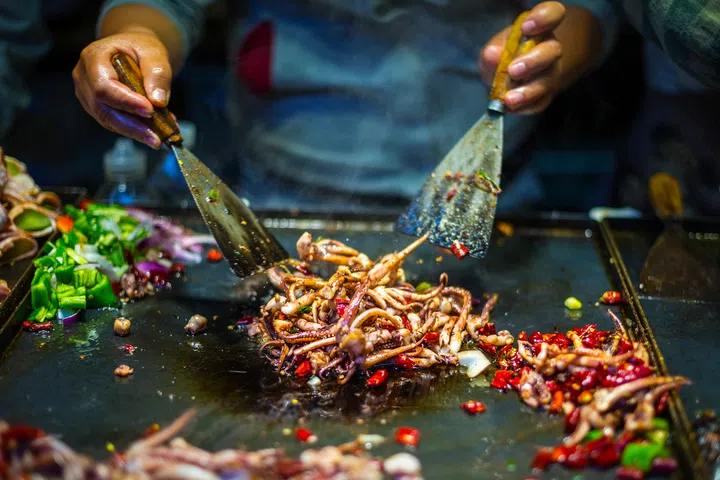 Chinese Chef making Iron Squid. Located in old town of Lijiang, Yunnan Province, China.