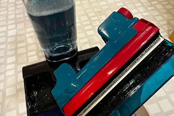 The new and improved dirty water tank of the Dyson Clean + Wash Hygiene