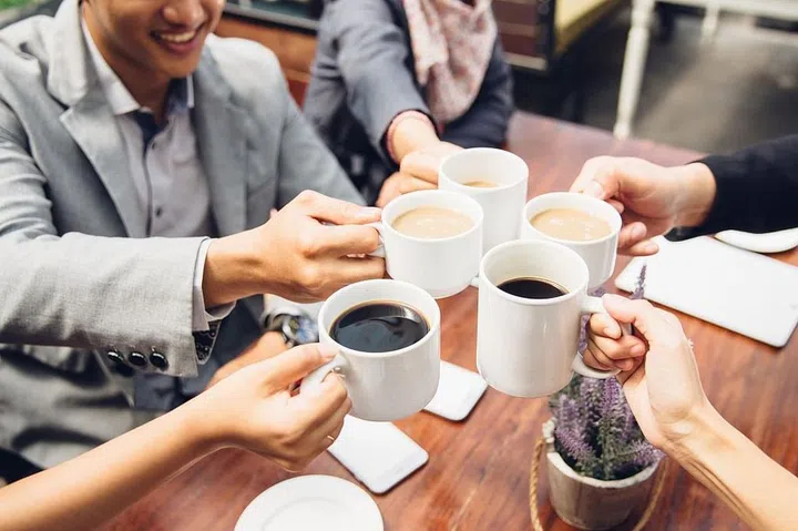 happy asian business Friends Cheering With Coffee at cafe
