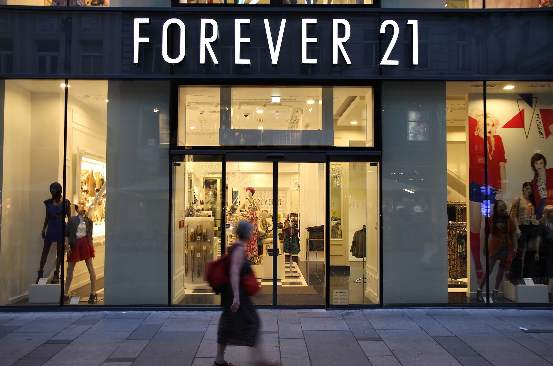 Vienna, Austria - September 4, 2011: Shopper walks past Forever 21 store on September 4, 2011 in Vienna. Forever 21 fashion label has 480 stores worldwide and had USD 2.6 bn revenue in 2011.