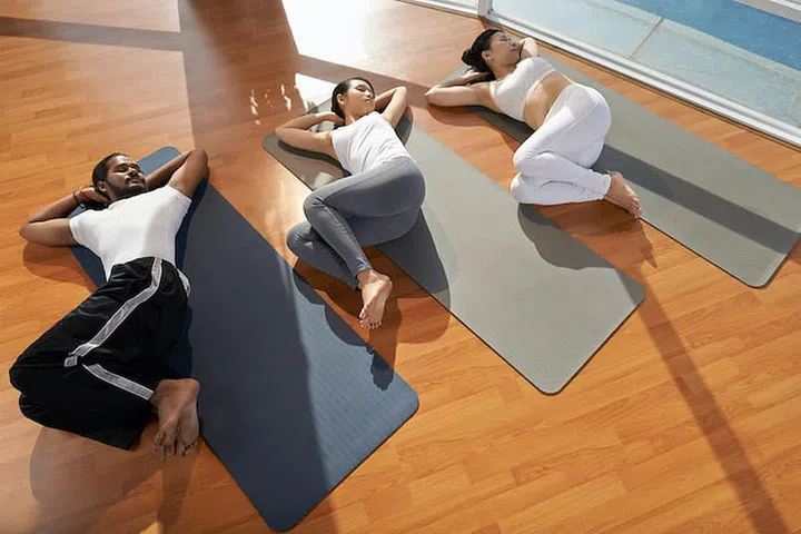 People performing supine spinal twist, view from above