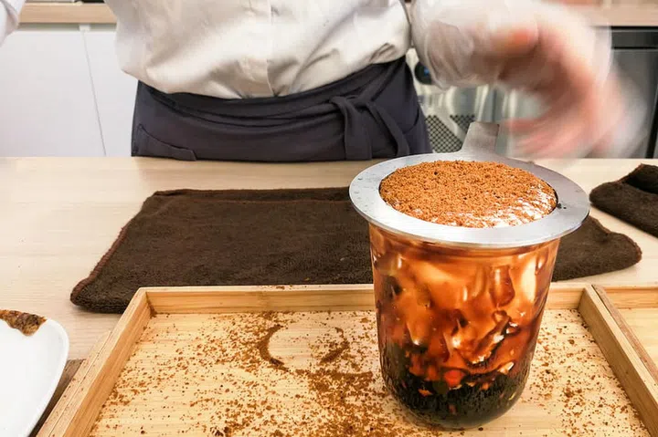 Worker preparing Boba or Bubble tea with caramel in shop.  Popular drinks originated from Taiwan.