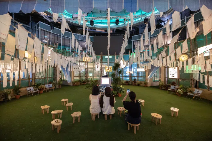 Overview of Kampong Chill, an installation by interdisciplinary artists Yok & Sheryo at the outdoor plaza of Capitol Singapore on Aug 19, 2025. The work invites visitors to arrive without agenda and rest without guilt, using bamboo as a metaphor for brevity to challenge myths that equate rest with laziness, slowness with failure, and wonder with wasted time.
