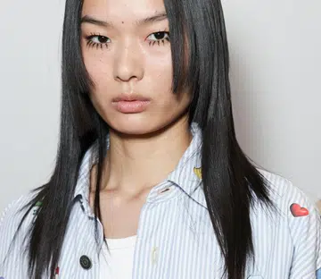 Model backstage with fake eyelashes