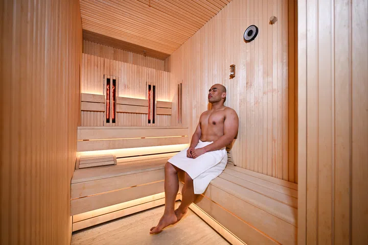 Muhammad Alfian Meswan using the dual therapy sauna at Damai spa and fitness centre, where he is a fitness team lead, 20 March 2025.
