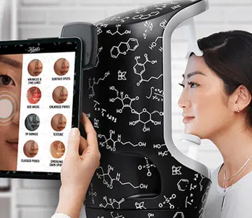 woman putting her face in a machine to test her skin health
