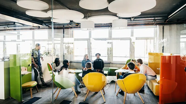 A seminar holding a seminar together between some of the team leader while working in a modern office space.