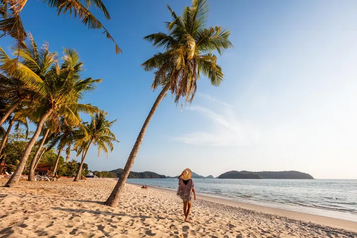 Woman at Pantai Cenang beach at sunset, Langkawi, Kedah, Malaysia