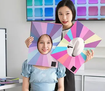 Colour consultant analysing skin tone undertones during consultation