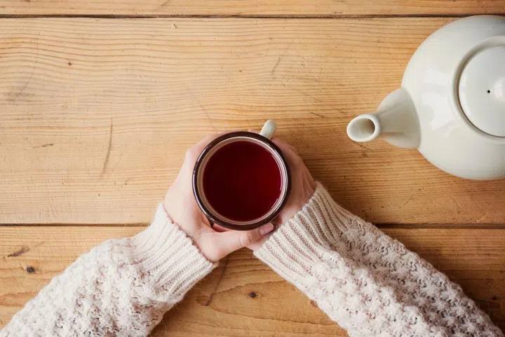 Beautiful woman relaxing at home with cup of  tea