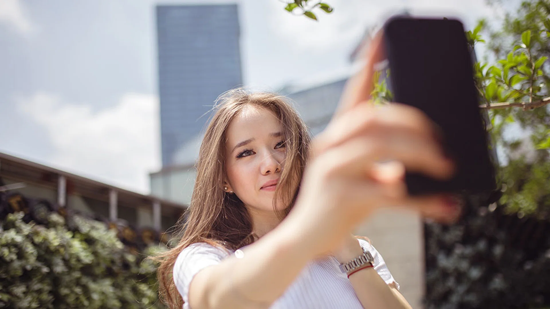 girl taking photo with phone
