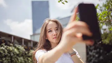 girl taking photo with phone
