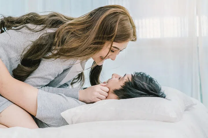 Closeup Happy Asian Lover kissing and hugging on the bed in bedroom at modern home, Couple and life style concept,
