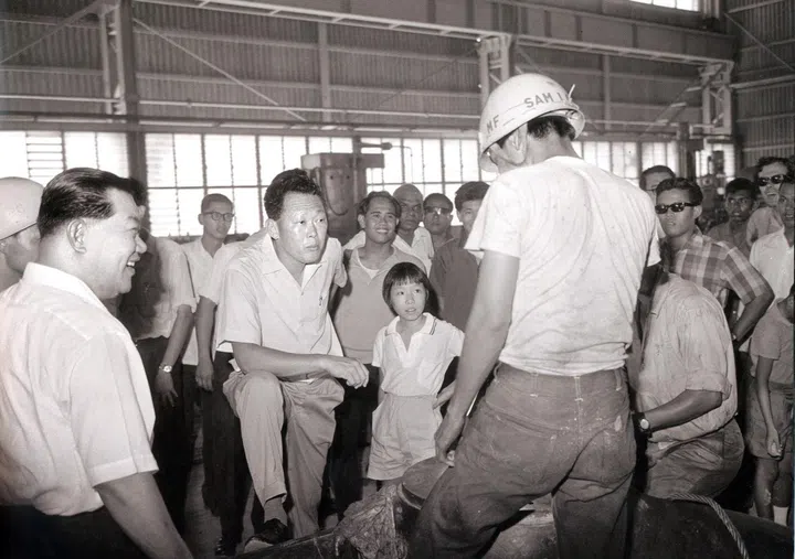 Mr Lee Kuan Yew talking to one of the factory workers during his visit to Jurong in 1965. Mr Lee's daughter Lee Wei Ling, accompanied him during the visit.
