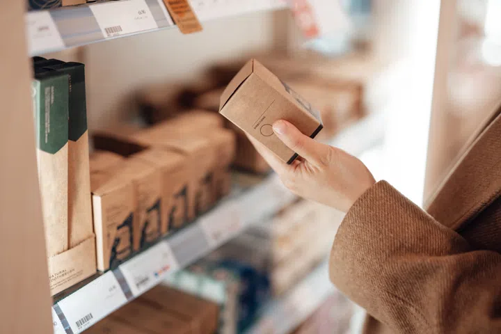 Young woman shopping eco friendly personal skincare products in zero waste store. Zero waste concept. Creating a plastic free planet.