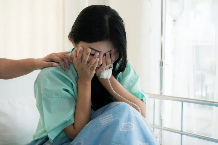 Asian young woman patient receiving bad news, Woman patient is desperate and crying. Her Mother support and comforting her patient with sympathy.