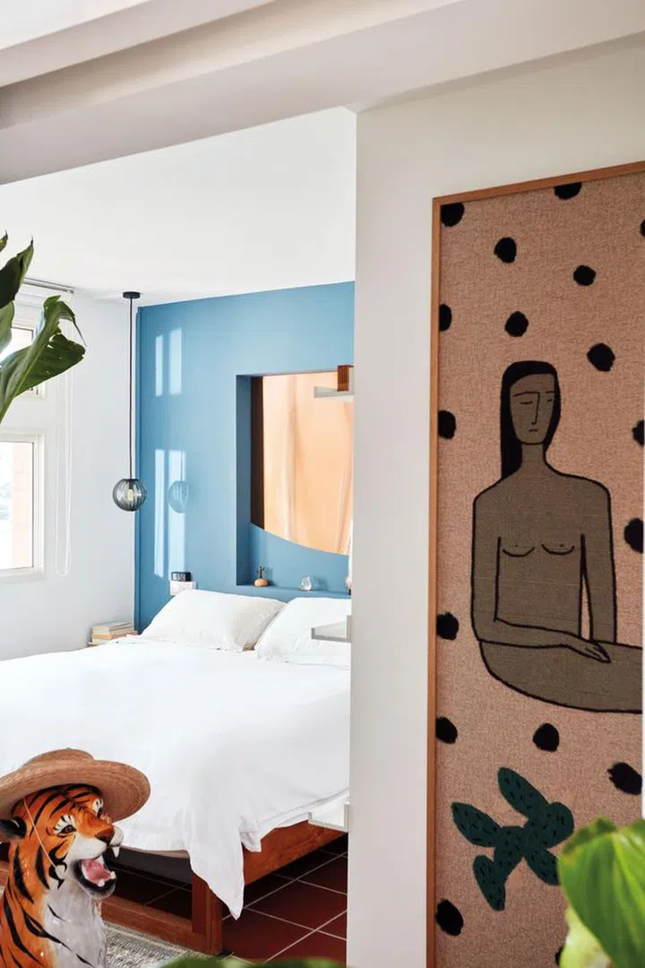 The master bedroom, formerly a common room, is bathed in abundant light, accentuating the eclectic collection of home decor pieces gathered from travels across the globe.Photo: Gan