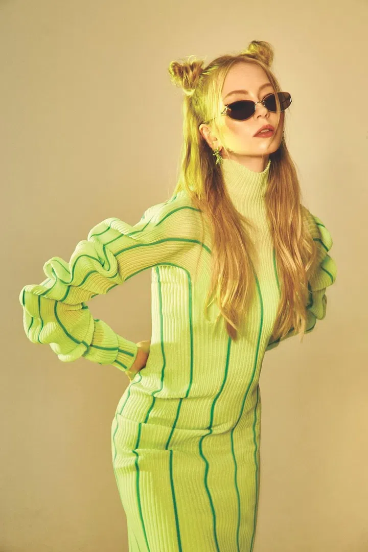 High-neck dress with gathered sleeves, and embellished earrings, Bottega Veneta. Sunglasses, Gentle Monster