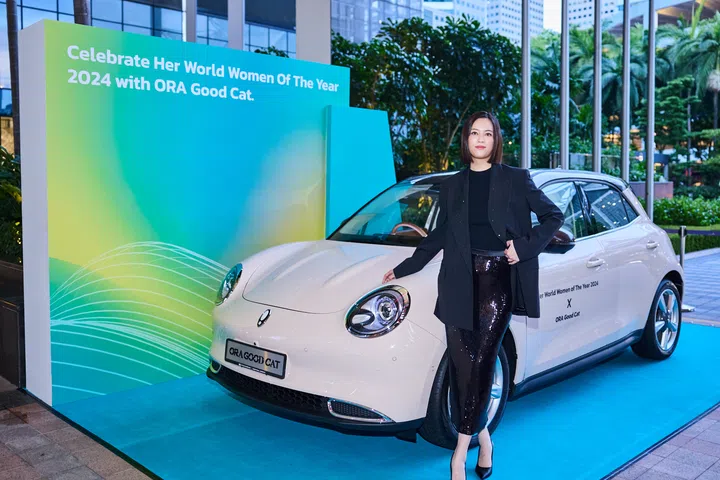 Actor Tay Ying poses with ORA’s limited edition Good Cat electric car
