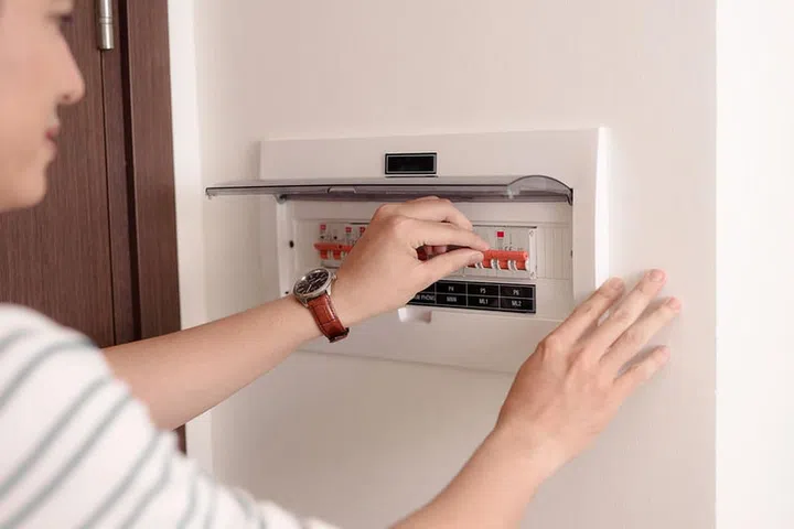 Hand including the switch on the electric panel