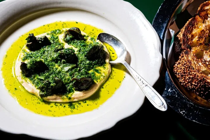 WASHINGTON, DC- MARCH 30: The Escargot on Hummus at La Shukran Restaurant photographed March 30, 2025 in Washington, DC. (Photo by Scott Suchman for The Washington Post via Getty Images)
