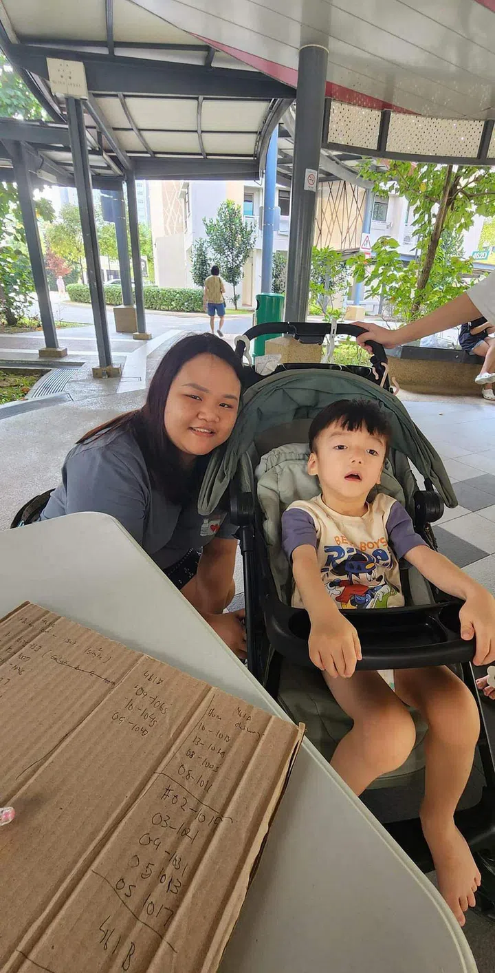 Ms Priscilla Ong’s daughter, Ms Stephanie Ong, with a rental flat resident in Yishun. PHOTO: COURTESY OF PRISCILLA ONG