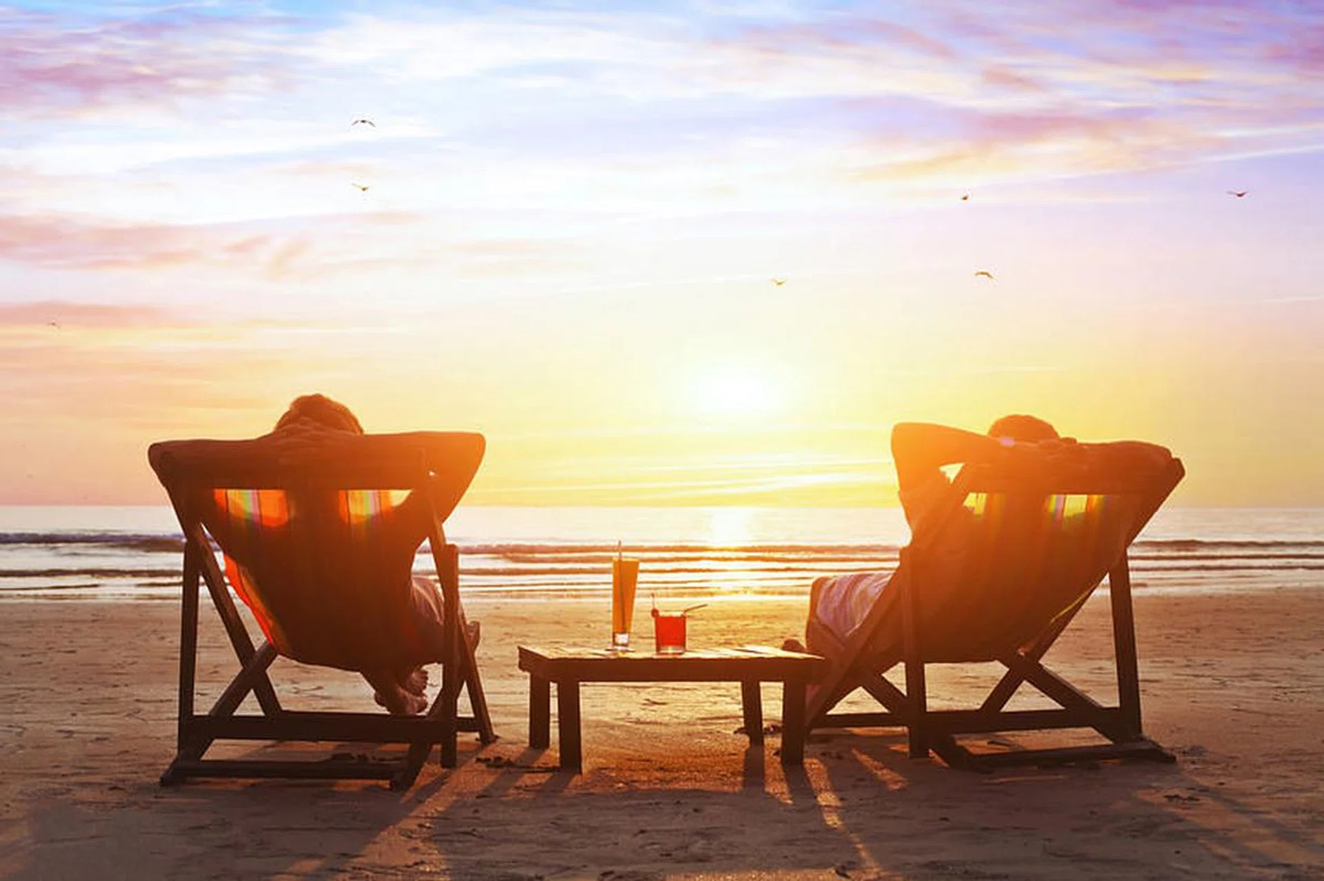 happy couple enjoy luxury sunset on the beach during summer vacations