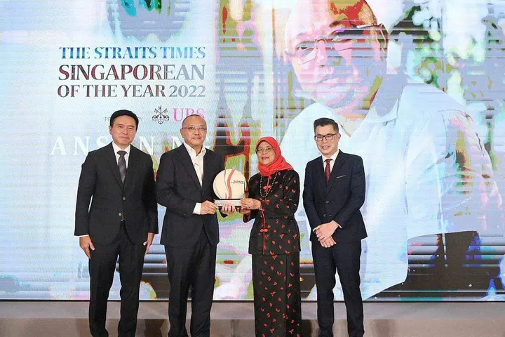 President Halimah Yacob presenting the Singaporean of the Year award to Mr Anson Ng on Feb 9, 2023. With them are UBS Asia-Pacific president Edmund Koh (left) and ST editor Jaime Ho. PHOTO: ST FILE