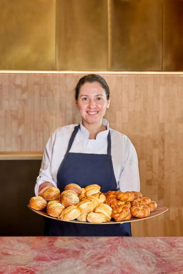 Fernanda, a pastry chef, shows off her house-made selection of bread that is served at the start of the meal. (Photo: Araya)