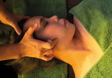 Close-up of woman receiving small face therapy massage for jawline slimming
