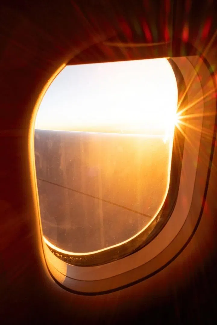 A stunning aerial view captured from an airplane window, showcasing clouds, sky, and a glimpse of the wing. The scene evokes feelings of travel, adventure, and wanderlust—perfect for aviation, vacation, and journey-themed visuals.