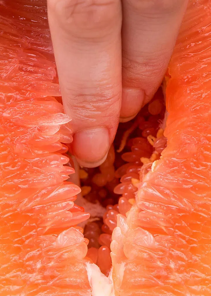 The vagina symbol. Two fingers in grapefruit. Masturbation. Sex concept.