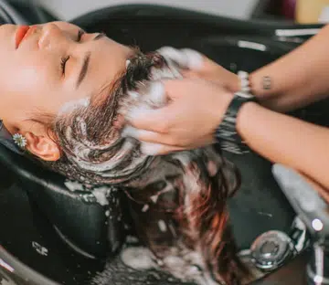 Woman trying a Korean head spa treatments in Singapore for improved hair health