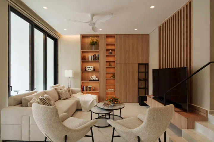 The rebuilt home balances openness with carefully defined zones, allowing three generations to live together while maintaining a sense of privacy and calm.