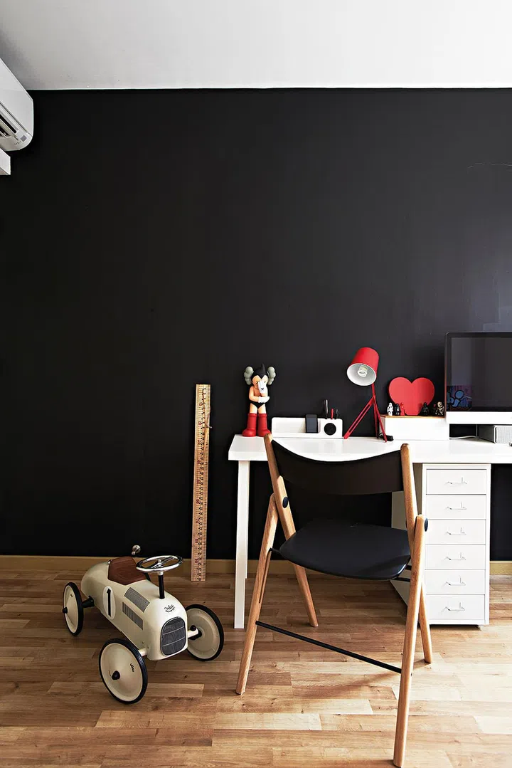 The future kids' room is painted in black chalkboard paint to allow for scribbling and drawing. Interior design by Space Sense