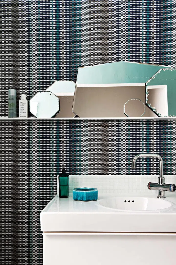 Instead of a single mirror, the homeowner opted for several panes in different shapes to create a conversation in the bathroom.