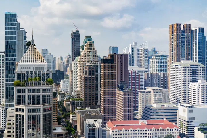 Closeup image of Bangkok cityscape. Modern cityscape surrounded with architectural building with day light and blue sky. Side view. Business background. Day light. Ornamented.