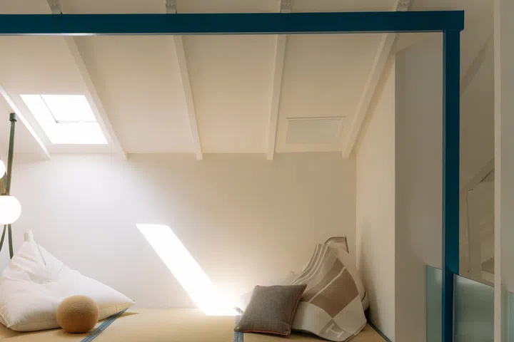 A raised tatami-inspired platform beneath the skylight offers a quiet spot to lounge with a book or simply bask in the afternoon sun.