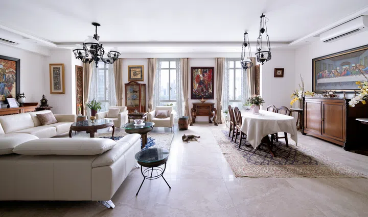 The large windows allow natural sunlight to filter into their 3-bedroom condo in Orchard Scotts, illuminating their wooden furniture and timeless decor.