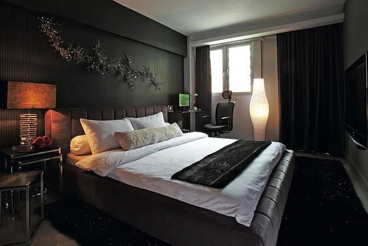 Utilising a monotone scheme and keeping the height of furnishings low are key to giving this room a spacious feel in interior designer John Susanto's 3-room resale HDB flat.