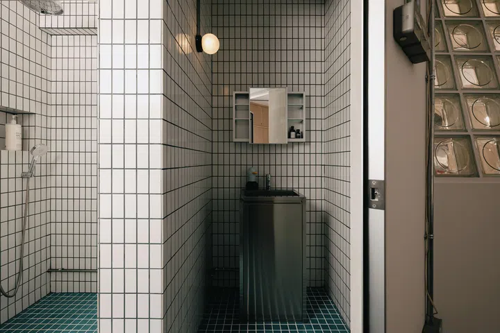 The bathroom, where tiles were inspired by swimming pools.