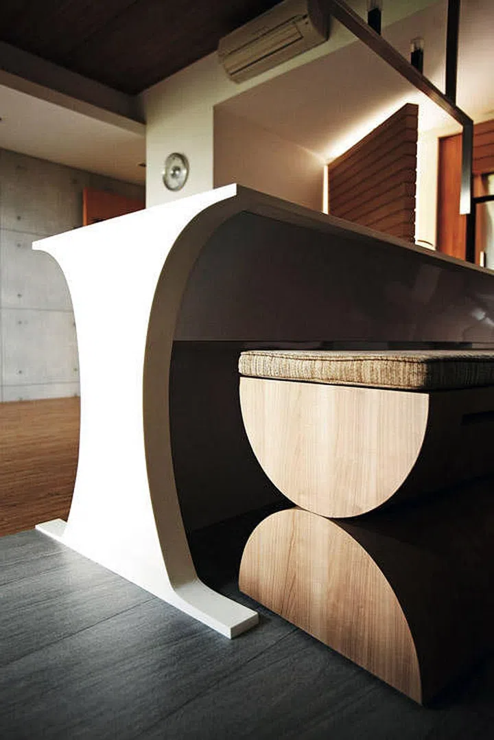 Two semi-circle solid wood logs make a stylistic solid wood dining bench. Interior design by Whiz Concept