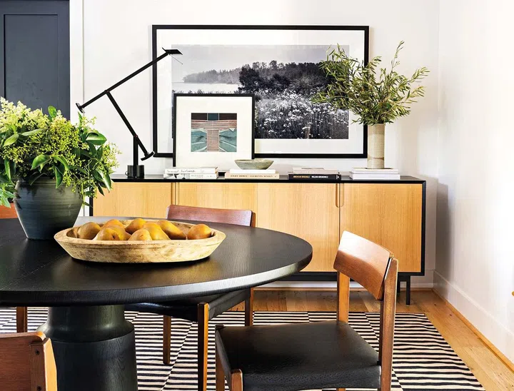 MDM Design Studio’s custom dining table and credenza pair well with midcentury chairs and Artemide Tizio lamp.