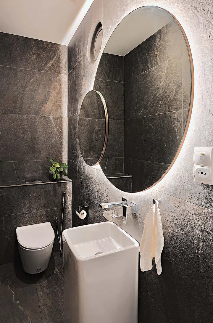 Echoing the circular courtyard is a round mirror in the powder room.