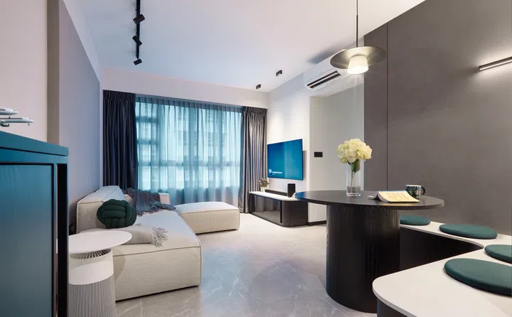 A close-up of the living area showing a feature wall extension and sleek modern furnishings.